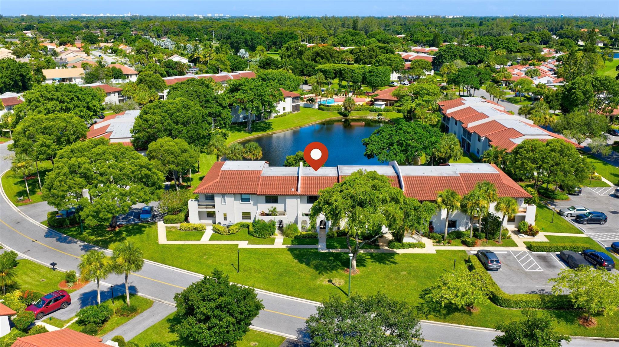 9232 Pecky Cypress Lane, Unit 2D Boca Raton, FL 33428 - Photo 1 of 20 an aerial view of residential houses with outdoor space and trees all around