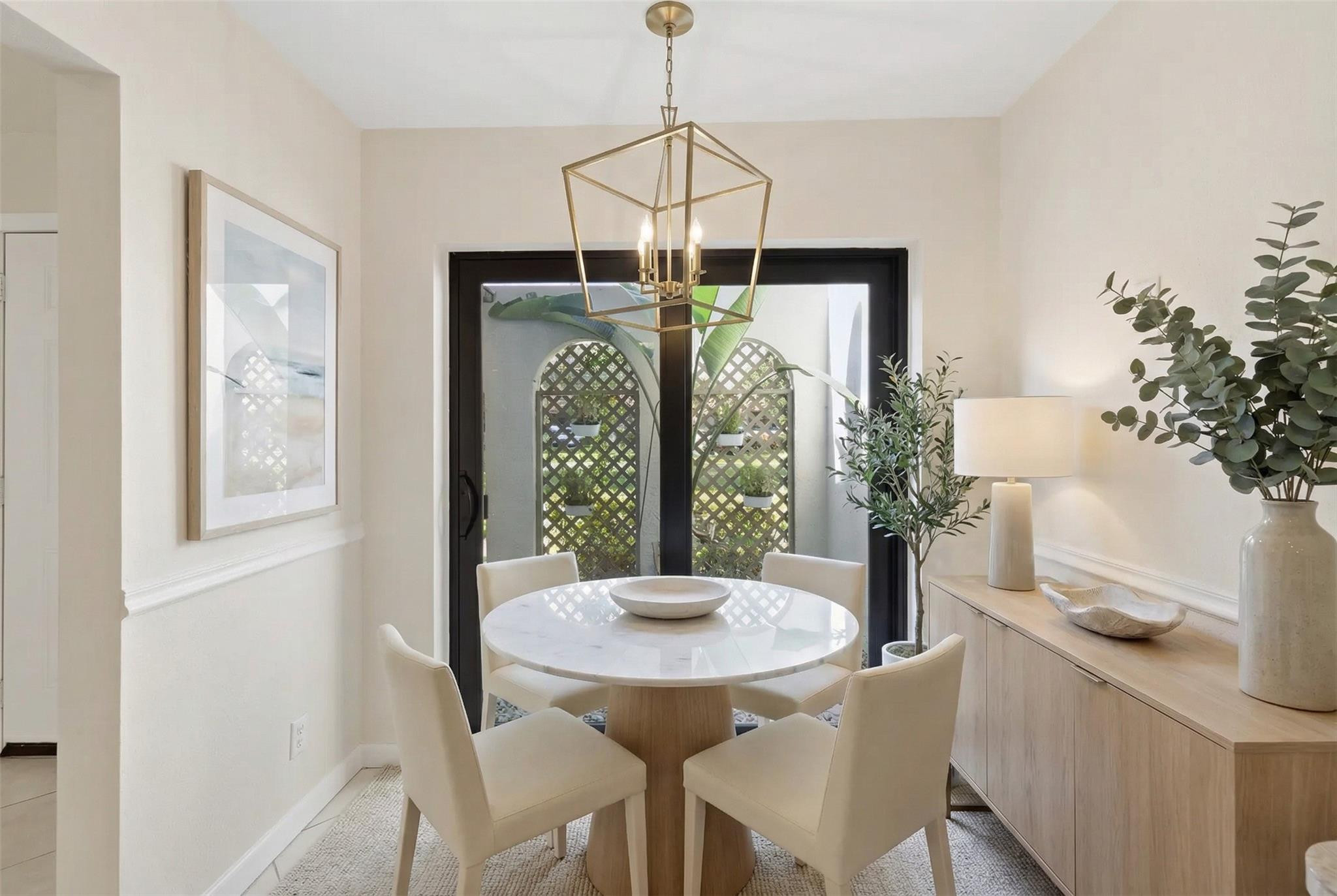 9232 Pecky Cypress Lane, Unit 2D Boca Raton, FL 33428 - Photo 11 of 20 a dining room with furniture and window