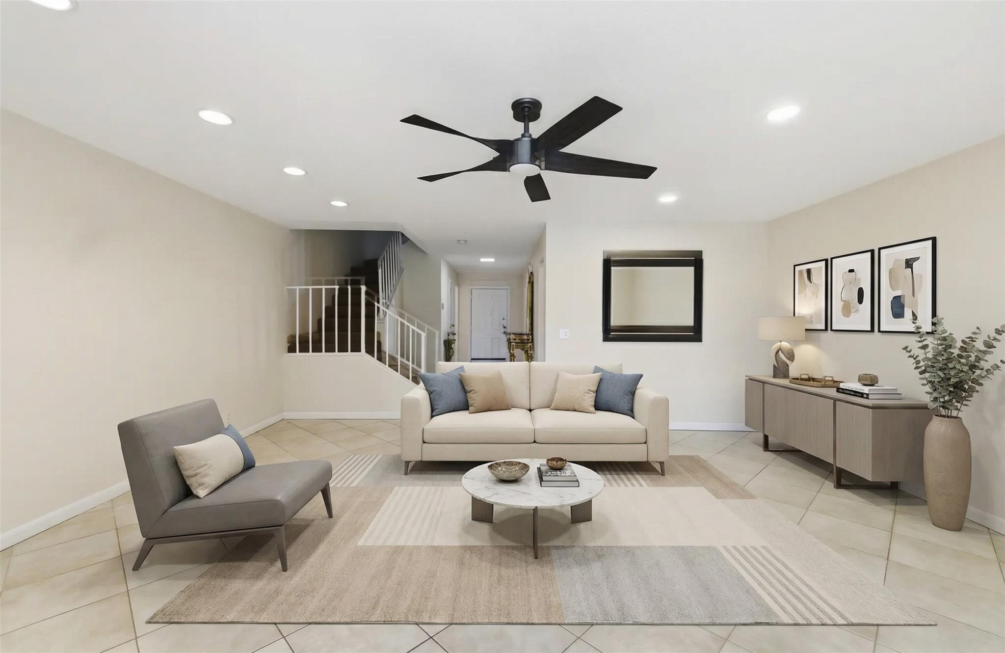 9232 Pecky Cypress Lane, Unit 2D Boca Raton, FL 33428 - Photo 13 of 20 a living room with furniture and a ceiling fan