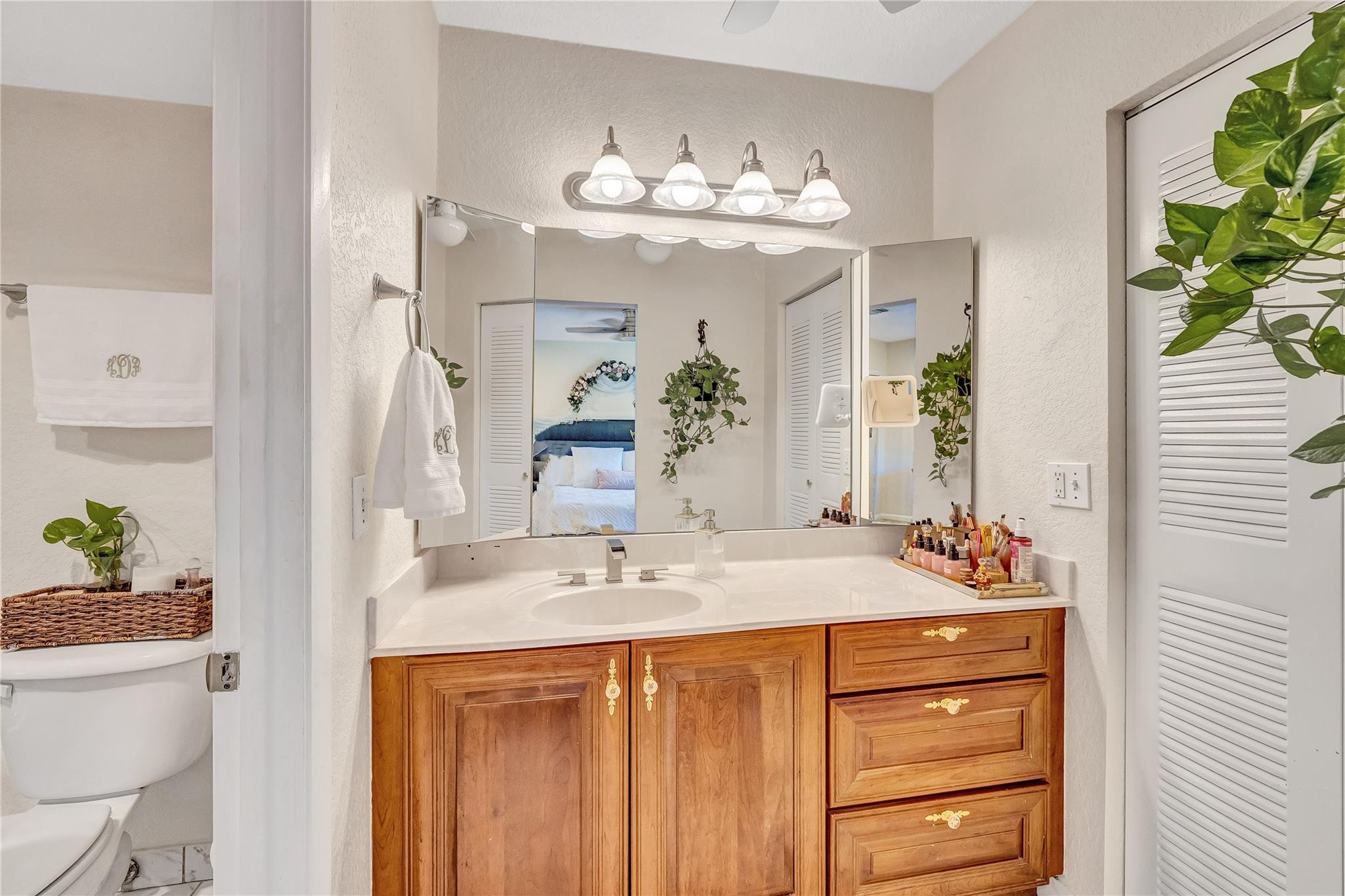 9232 Pecky Cypress Lane, Unit 2D Boca Raton, FL 33428 - Photo 15 of 20 a bathroom with a sink vanity and a mirror