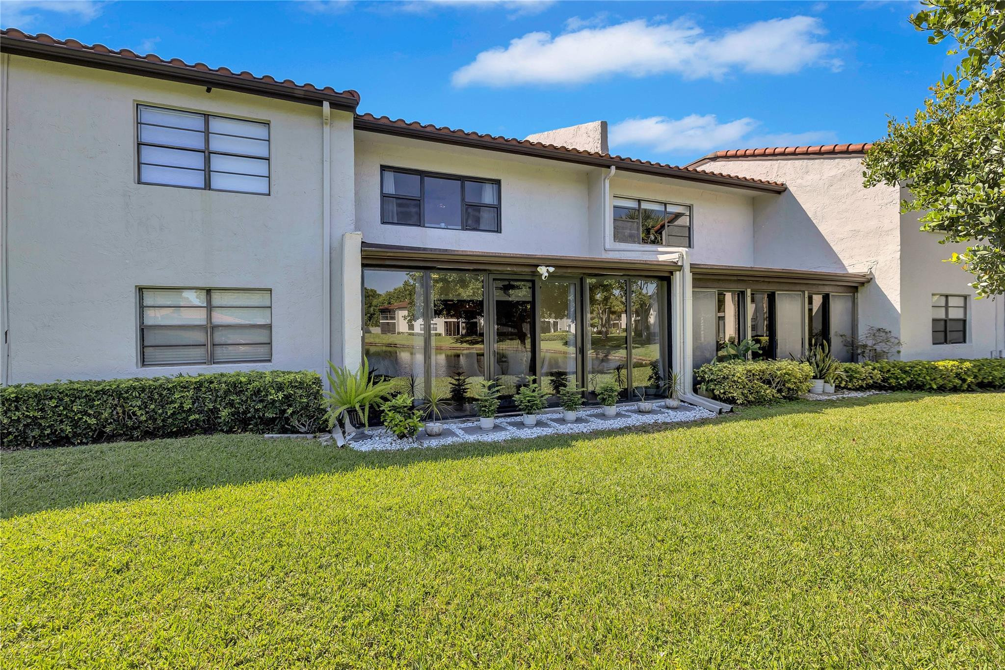9232 Pecky Cypress Lane, Unit 2D Boca Raton, FL 33428 - Photo 3 of 20 front view of a house with a yard
