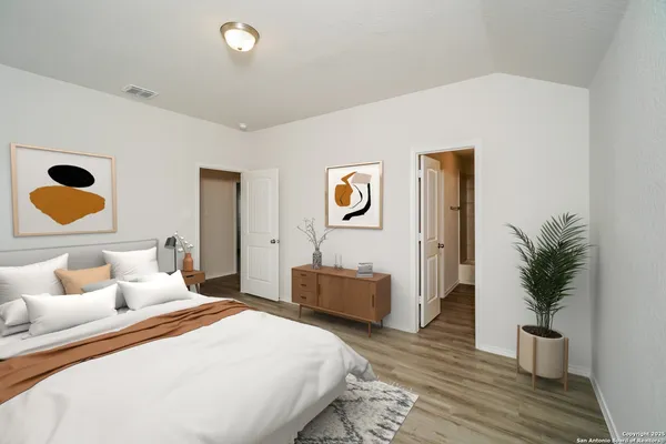 a bedroom with bed and wooden floor