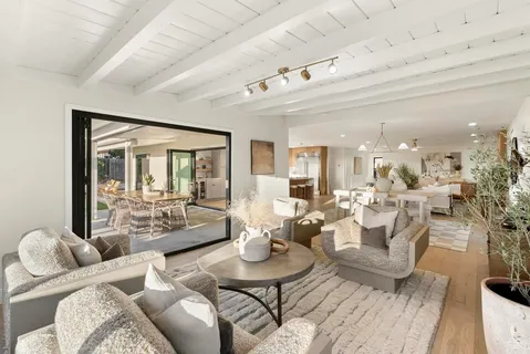 a view of a patio with a table chairs and a backyard