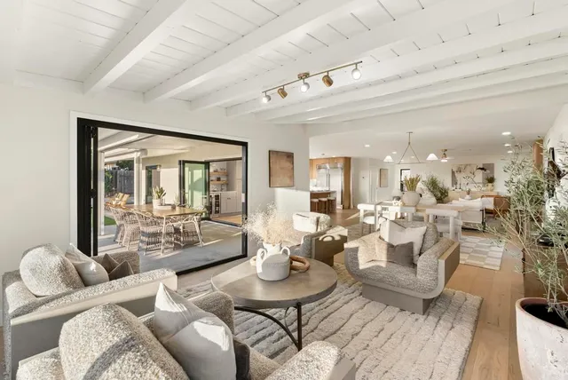 a view of a patio with a table chairs and a backyard