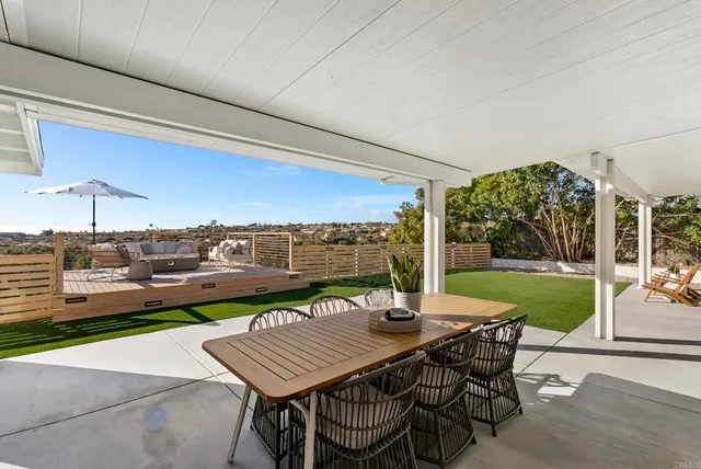 a view of a house with backyard porch and sitting area