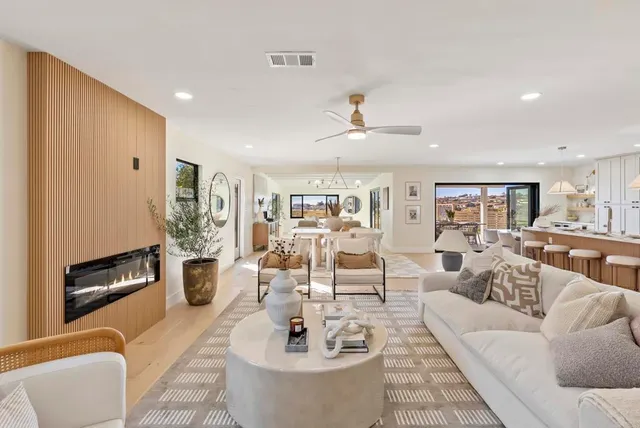 a living room with furniture and a view of kitchen