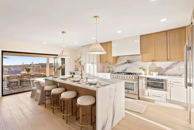 a large kitchen with a table and chairs