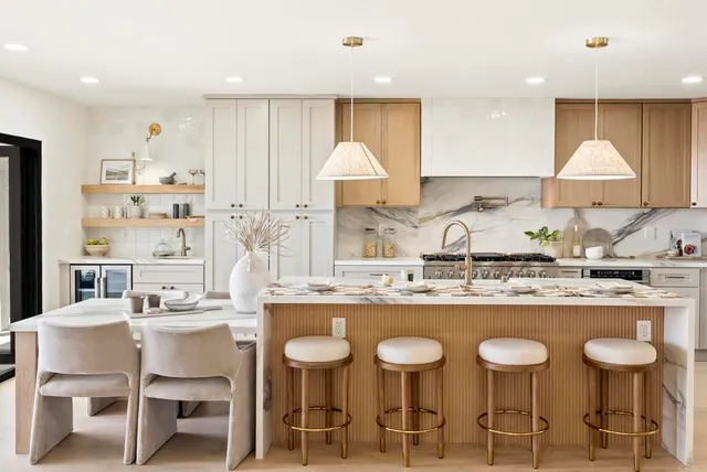 a kitchen with stainless steel appliances granite countertop a stove a sink and a white cabinets