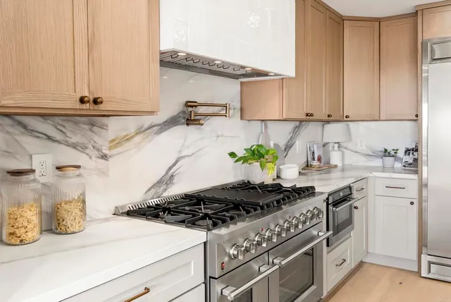 a large kitchen with a table and chairs
