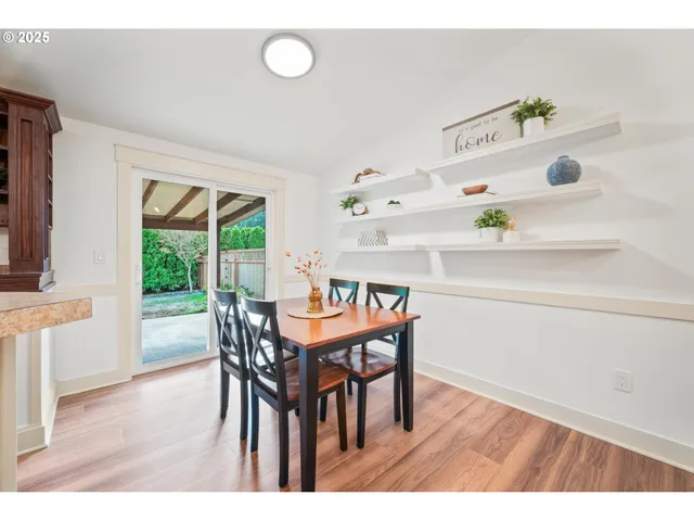 a view of a dining room with furniture and a window