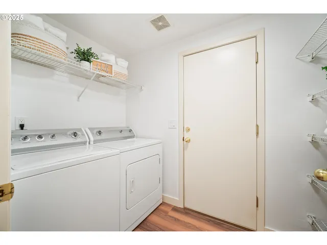 a utility room with cabinets washer and dryer