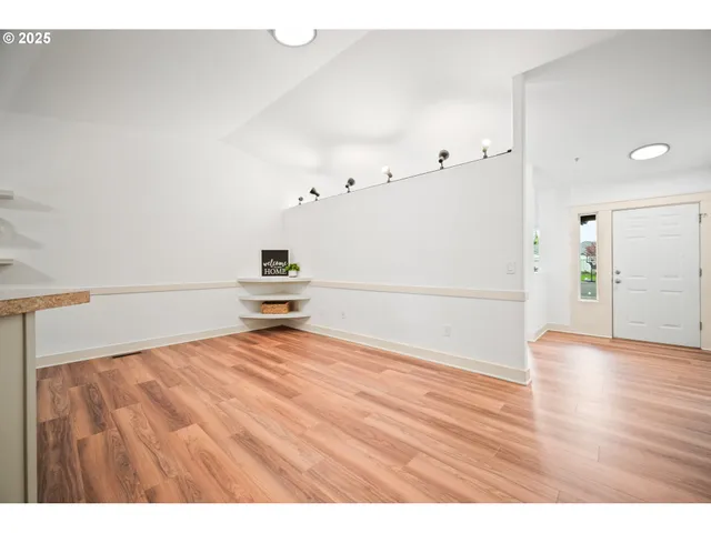 a view of a room with wooden floor