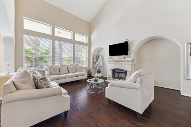 a living room with furniture a fireplace and a flat screen tv