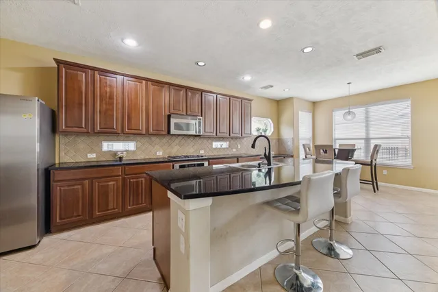 a kitchen with a sink cabinets and window