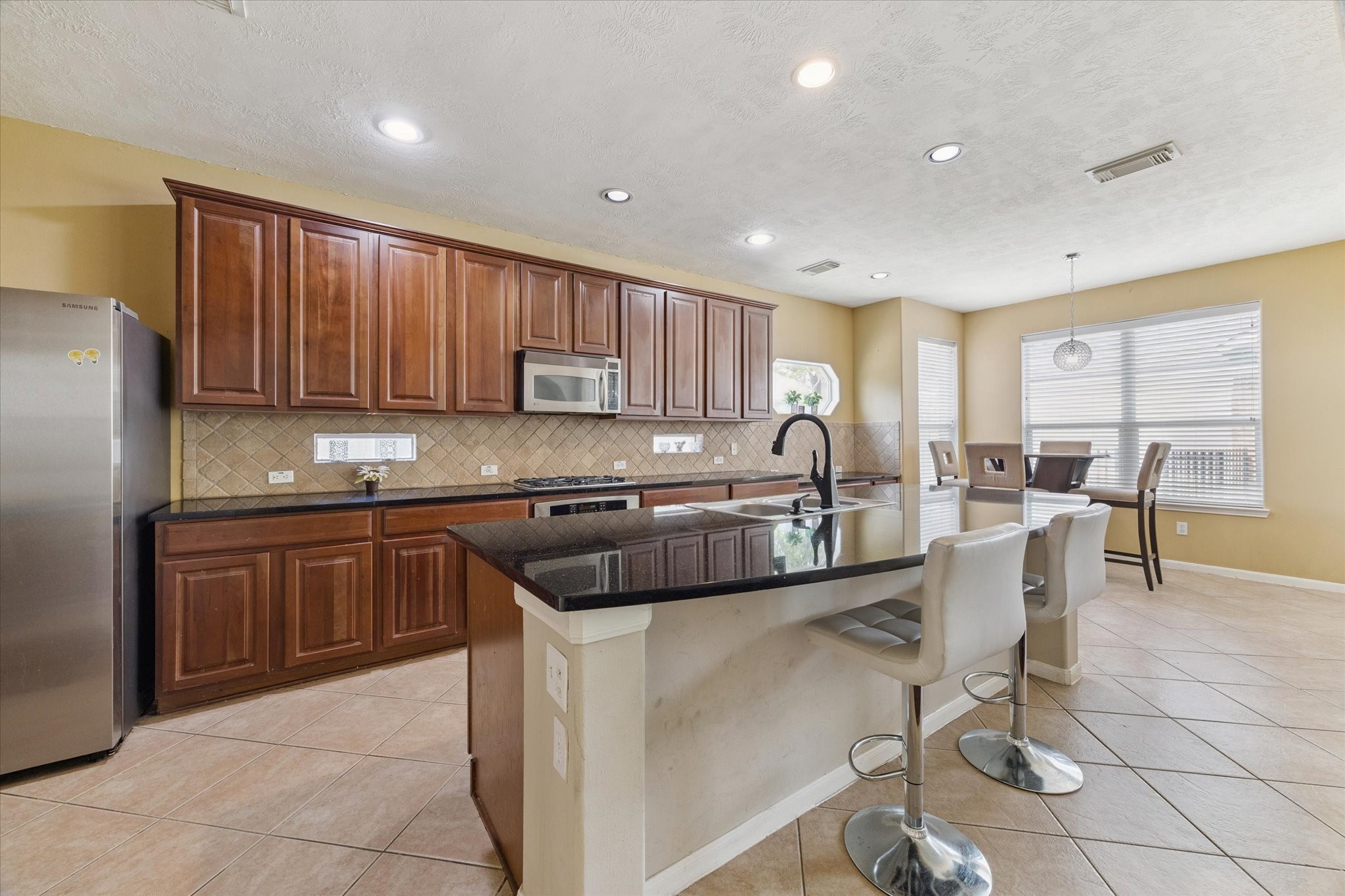 6306 Amelia Springs Drive Spring, TX 77379 - Photo 15 of 37 a kitchen with a sink cabinets and window