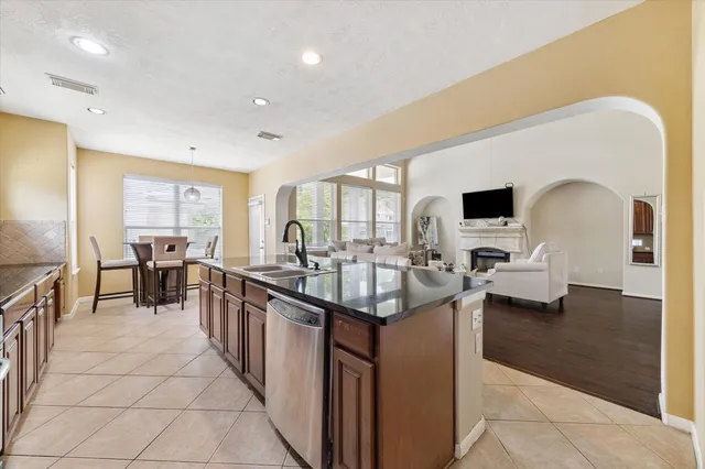 a kitchen with counter top space and living room