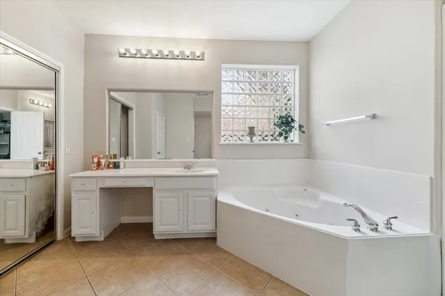 a bathroom with a bathtub a sink and a window