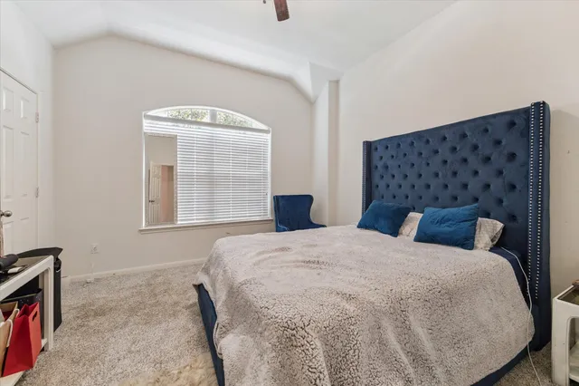 a bedroom with a bed and painting on the wall