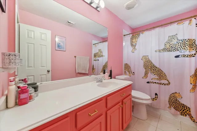 a bathroom with a sink vanity tub and toilet