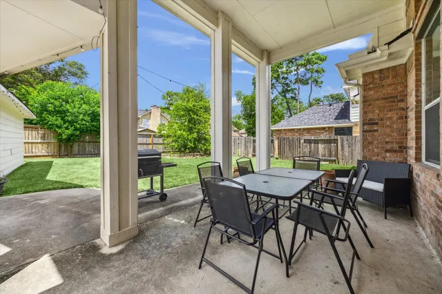 a view of a patio with a table and chairs