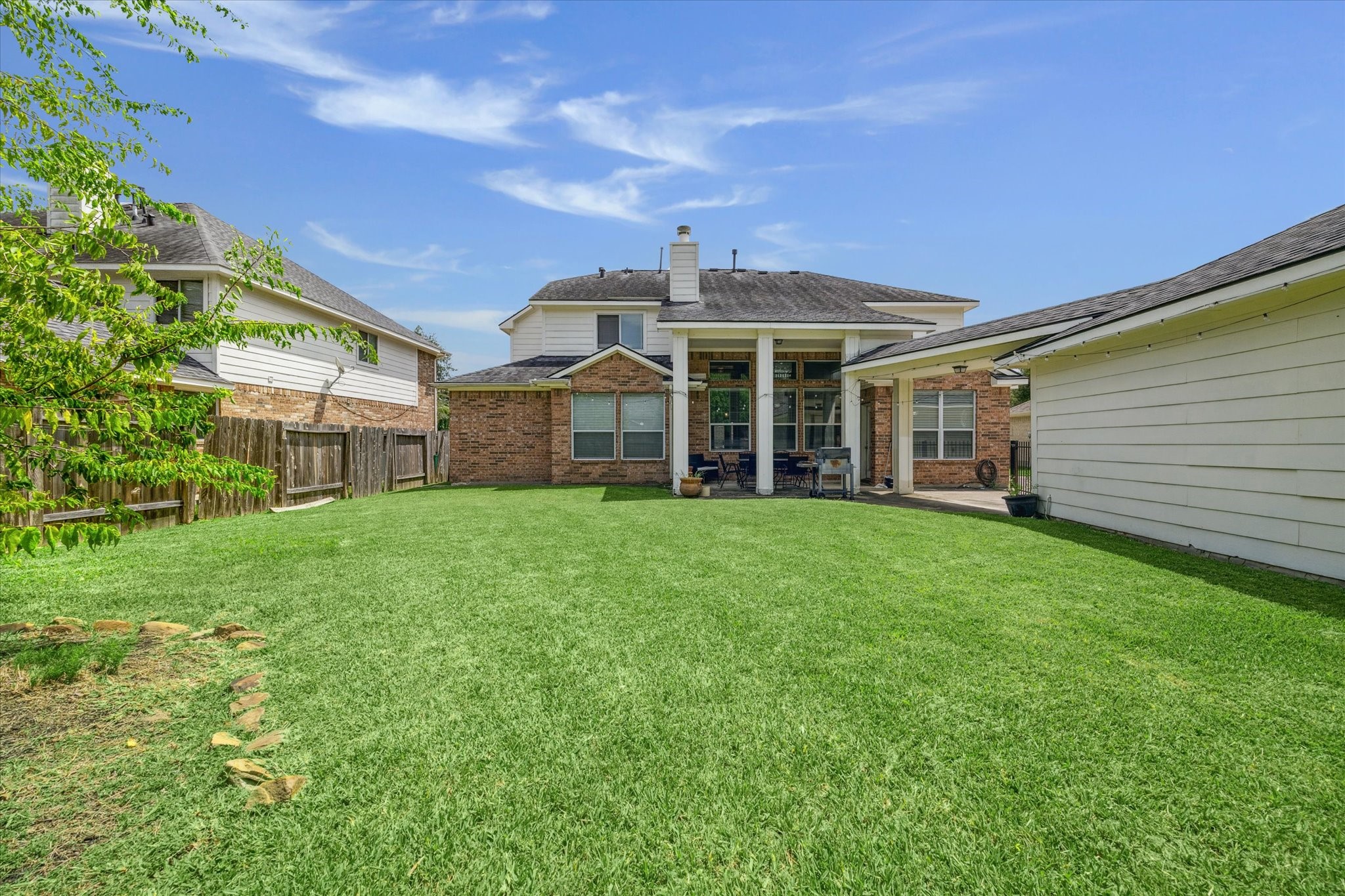 6306 Amelia Springs Drive Spring, TX 77379 - Photo 33 of 37 a view of a white house that has a small yard and large trees