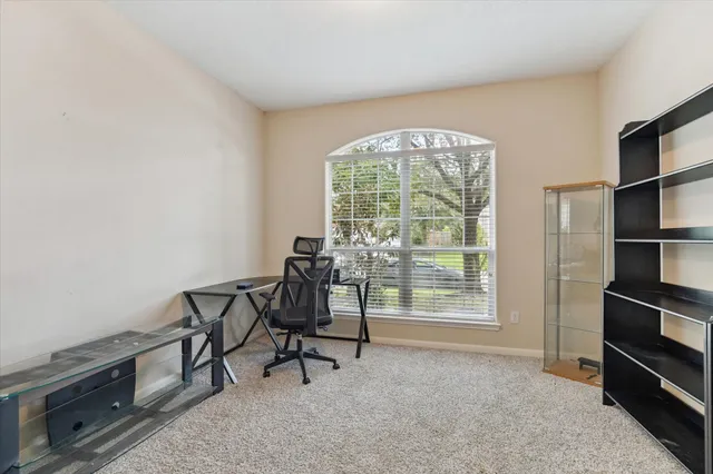 a view of a livingroom with furniture and a window
