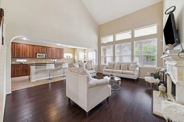 a living room with furniture wooden floor and a flat screen tv