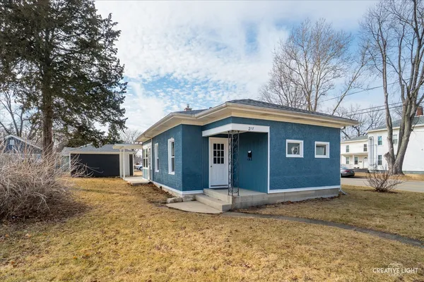 a house that has a tree in front of it