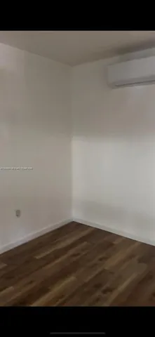 a view of room with wooden floor