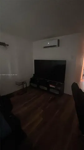 a living room with furniture and a lamp