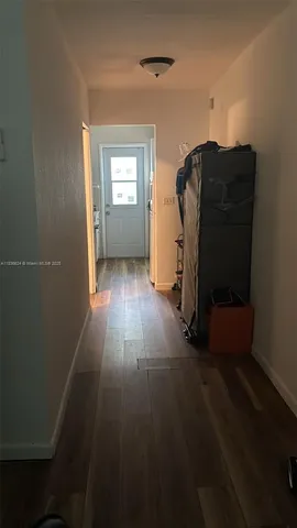 a view of wooden floor and windows in a room