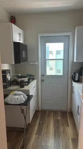 a kitchen with a stove a sink and a refrigerator