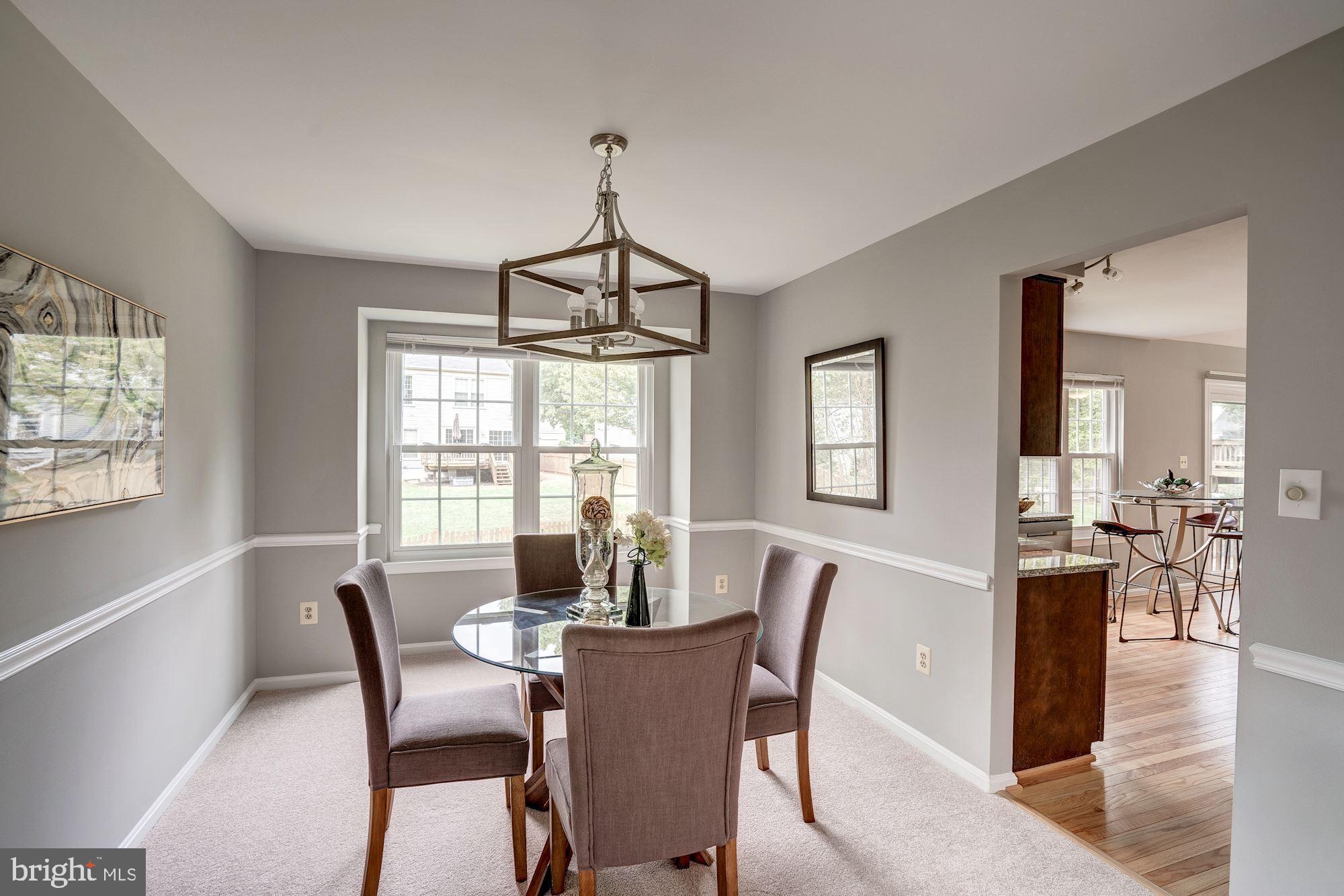 2986 Emerald Chase Drive Herndon, VA 20171 - Photo 7 of 36 Dining room with chair rail & statement chandelier