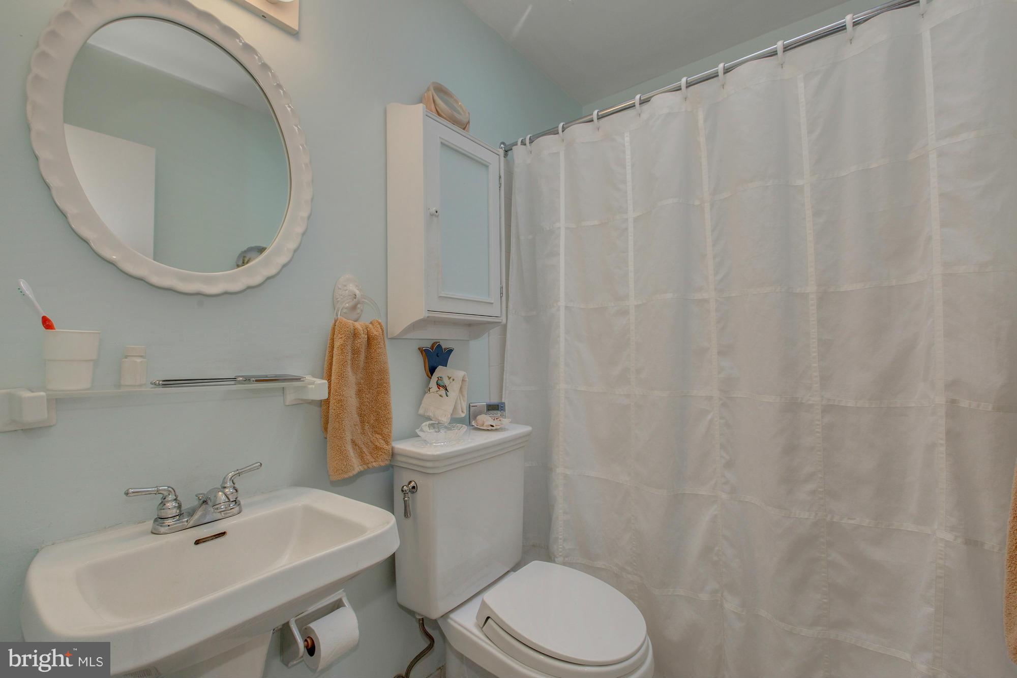 3916 Rickover Road Silver Spring, MD 20902 - Photo 11 of 23 a bathroom with a sink a toilet and a mirror