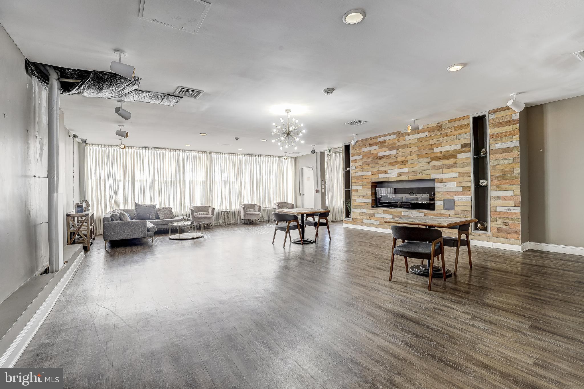 6606 Park Heights Avenue, Unit 111 Baltimore, MD 21215 - Photo 26 of 32 a living room with furniture and a wooden floor