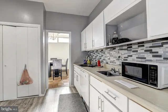 a kitchen with stainless steel appliances a stove a sink and a microwave