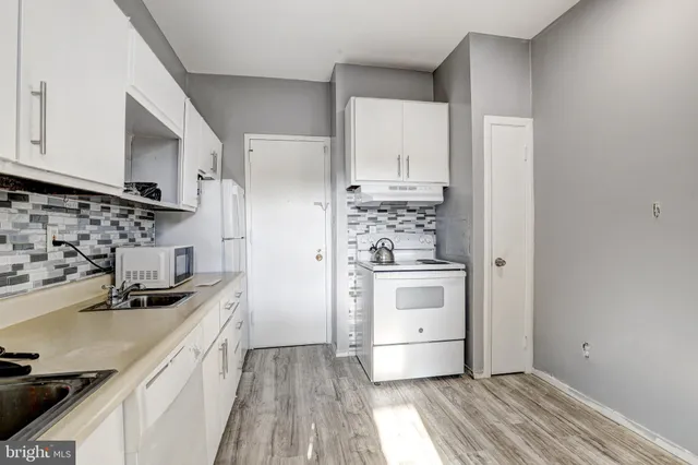 a kitchen with stainless steel appliances a sink stove and refrigerator