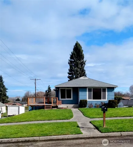a front view of a house with a yard table and chairs