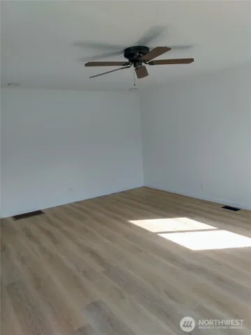 a view of a room with a ceiling fan