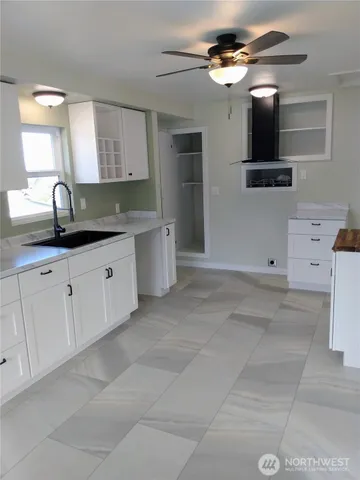 a kitchen with a sink cabinets and window