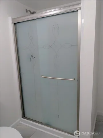 a view of empty room with wooden floor and window