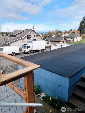 a view of a balcony with wooden benches