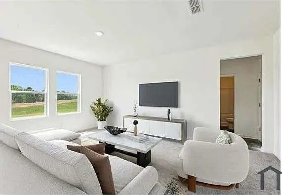 a living room with furniture and a flat screen tv