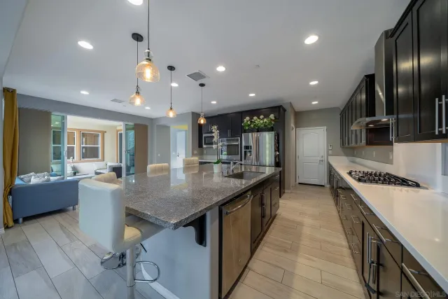 a kitchen with granite countertop a sink a stove and cabinets