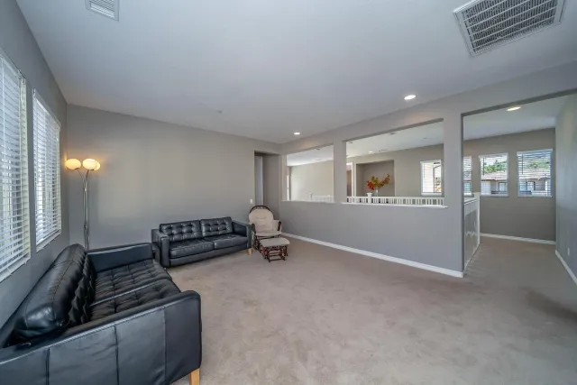 a bed sitting in a bedroom next to a window