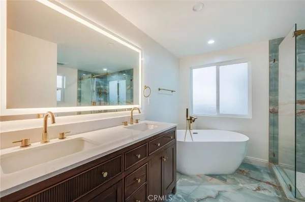 a bathroom with a large tub and sink
