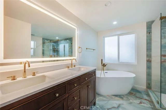 a bathroom with a large tub and sink