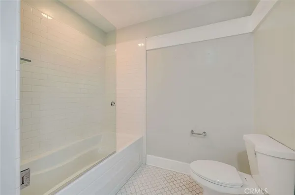 a bathroom with a shower and a toilet