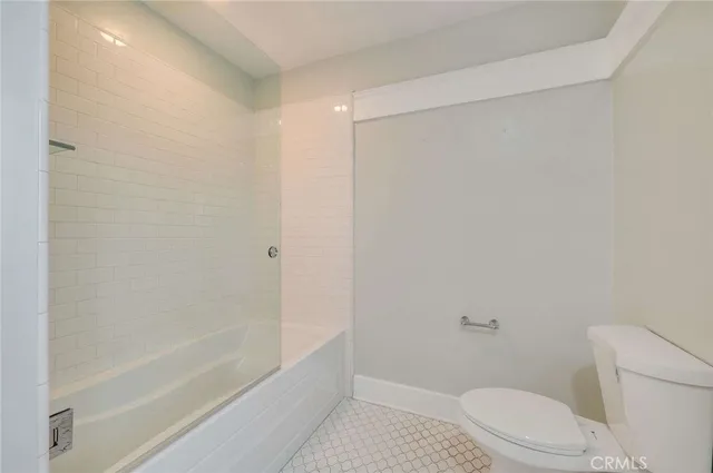 a bathroom with a shower and a toilet