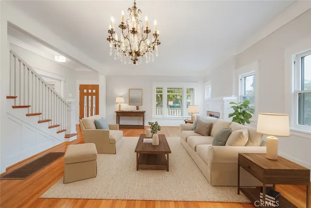 a living room with furniture or chandelier and a wooden floor